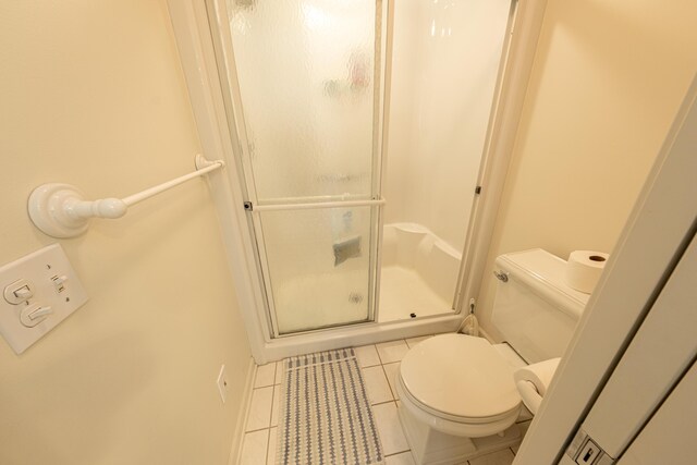 14 N Lighthouse Dr, Mears, MI 49436 - full bath featuring toilet, tile patterned floors, and a stall shower