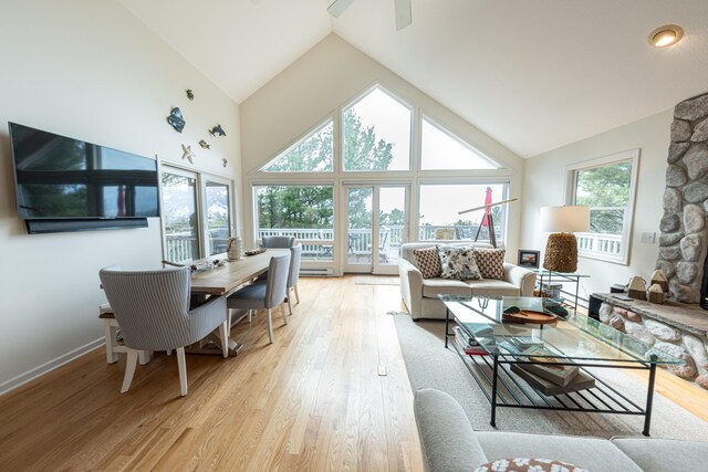 14 N Lighthouse Dr, Mears, MI 49436 - living room with high vaulted ceiling, ceiling fan, and light wood finished floors