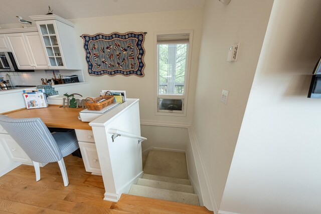 14 N Lighthouse Dr, Mears, MI 49436 - dining room with baseboards, stairs, and light wood-style flooring