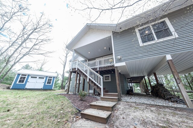 14 N Lighthouse Dr, Mears, MI 49436 - back of house featuring a storage shed, a deck, a carport, an outdoor structure, and stairs
