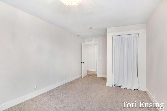 unfurnished bedroom with visible vents, carpet, and baseboards