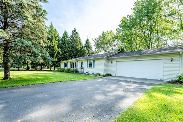 3715 Glen Haven Rd, Saint Joseph, MI 49085 - ranch-style home with driveway, an attached garage, and a front yard