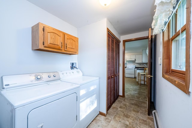 3715 Glen Haven Rd, Saint Joseph, MI 49085 - laundry area featuring cabinet space, washer and dryer, stone finish floors, baseboards, and baseboard heating