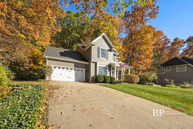 traditional-style home with concrete driveway, a front lawn, and a garage