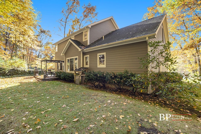 back of property featuring a lawn and a wooden deck