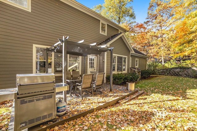 rear view of property featuring a patio, a yard, and a pergola