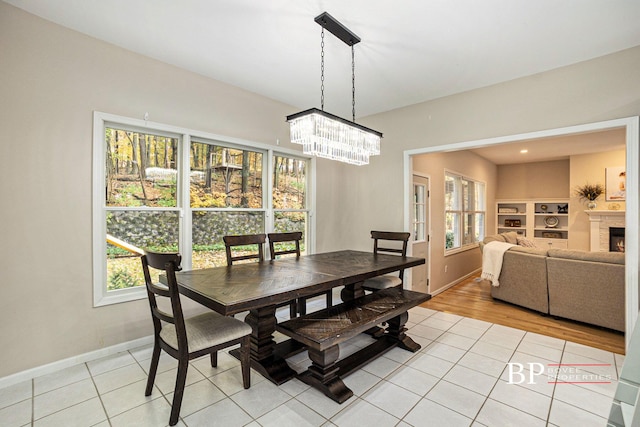 dining room with baseboards, light tile patterned flooring, and a wealth of natural light