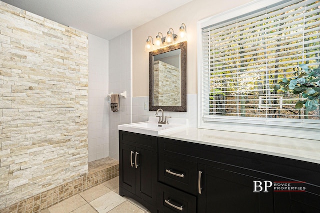 full bathroom featuring vanity and a walk in shower