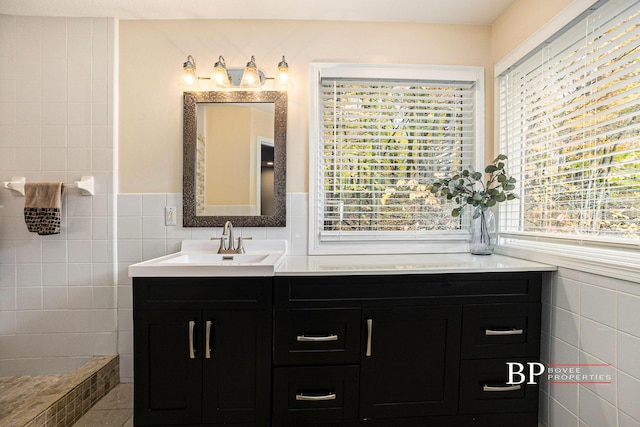 bathroom featuring tile walls and vanity