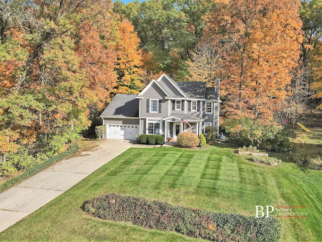 view of front of property featuring concrete driveway, an attached garage, a chimney, and a front yard