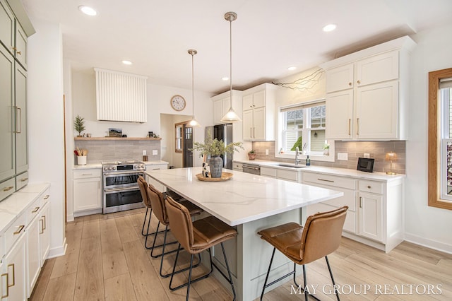 13460 Cottage View Ct, Gowen, MI 49326 - kitchen with stainless steel appliances, a sink, open shelves, light wood-style floors, and recessed lighting