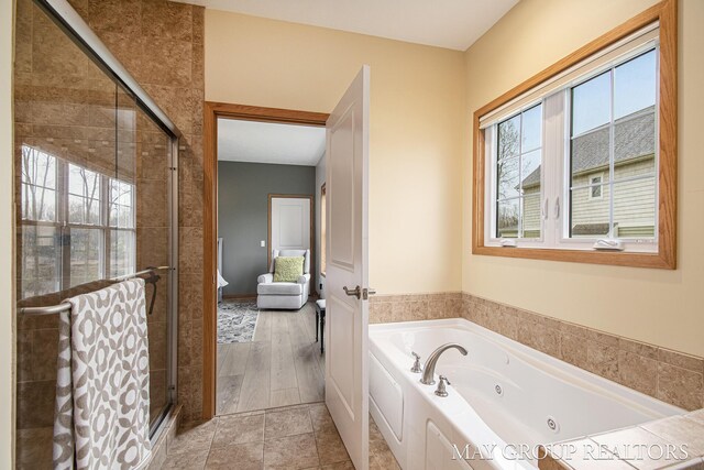 13460 Cottage View Ct, Gowen, MI 49326 - bathroom featuring a shower stall and a tub with jets