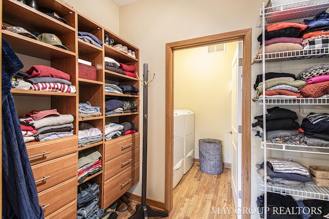 13460 Cottage View Ct, Gowen, MI 49326 - spacious closet featuring wood finished floors and washer / dryer