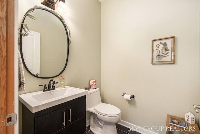 13460 Cottage View Ct, Gowen, MI 49326 - bathroom featuring toilet, vanity, tile patterned flooring, and baseboards