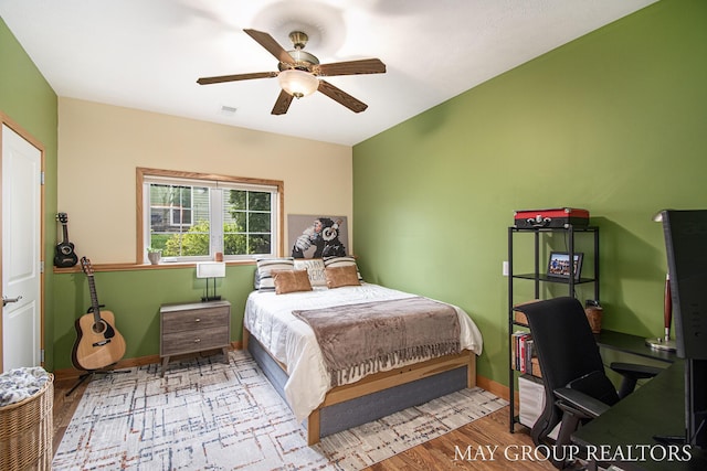 13460 Cottage View Ct, Gowen, MI 49326 - bedroom featuring wood finished floors, baseboards, a desk, and ceiling fan