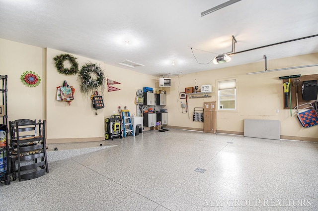 13460 Cottage View Ct, Gowen, MI 49326 - garage featuring a garage door opener and baseboards