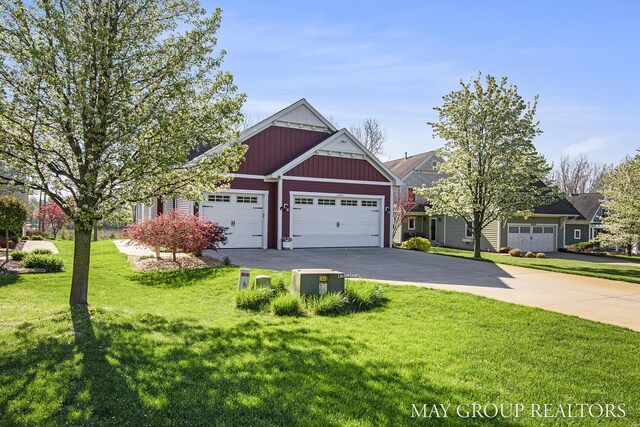 13460 Cottage View Ct, Gowen, MI 49326 - view of front of home featuring an attached garage, driveway, board and batten siding, and a front lawn