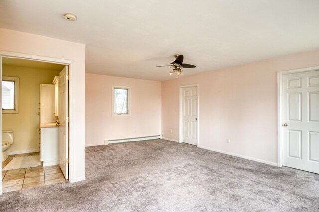 20425 Thornapple Ln, Big Rapids, MI 49307 - interior space with a ceiling fan, baseboards, ensuite bathroom, light colored carpet, and a baseboard radiator