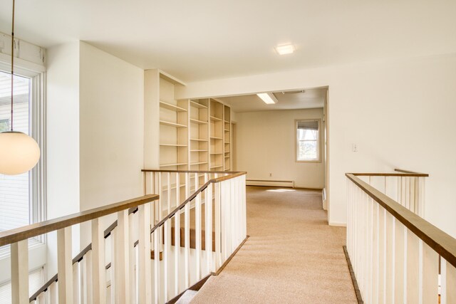 20425 Thornapple Ln, Big Rapids, MI 49307 - hall with light colored carpet, baseboards, baseboard heating, and an upstairs landing