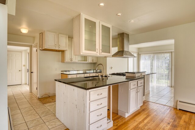 20425 Thornapple Ln, Big Rapids, MI 49307 - kitchen featuring dark countertops, a sink, recessed lighting, island range hood, and glass insert cabinets