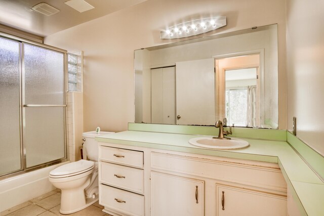 20425 Thornapple Ln, Big Rapids, MI 49307 - bathroom with vanity, visible vents, toilet, tile patterned floors, and enclosed tub / shower combo
