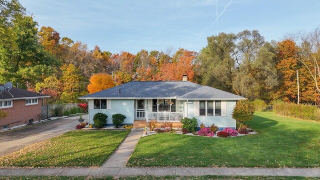 409 Louise Ave, Dowagiac, MI 49047 - single story home featuring a shingled roof, a front lawn, a chimney, covered porch, and driveway
