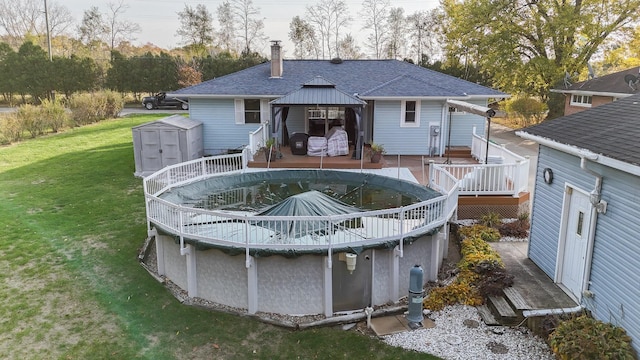 409 Louise Ave, Dowagiac, MI 49047 - rear view of house with a shingled roof, a gazebo, a deck, a shed, and an outdoor structure
