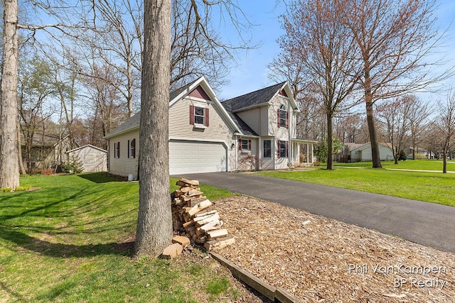 view of side of property featuring a lawn, a garage, and driveway