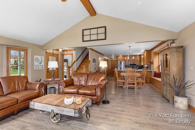 living room with light wood-style flooring, stairs, high vaulted ceiling, and beamed ceiling