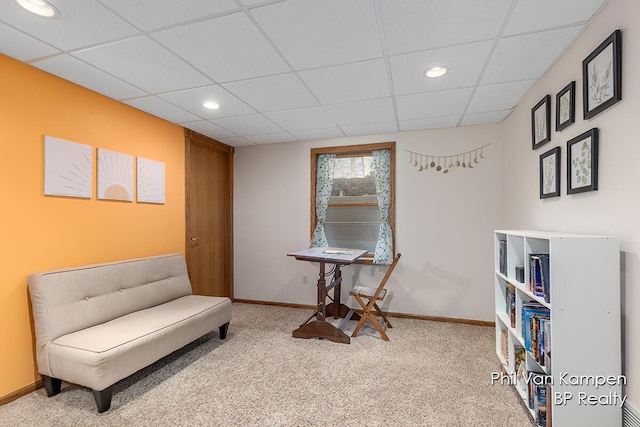 living area featuring recessed lighting, baseboards, a drop ceiling, and carpet