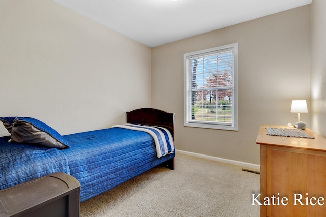 carpeted bedroom featuring baseboards and visible vents