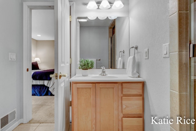 ensuite bathroom with visible vents, vanity, an enclosed shower, tile patterned floors, and ensuite bath