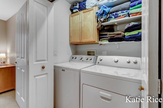 laundry area featuring light colored carpet, cabinet space, and washer and dryer