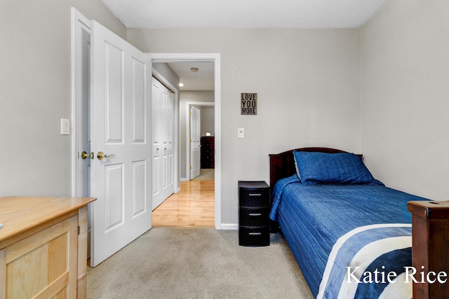 bedroom featuring baseboards and light carpet
