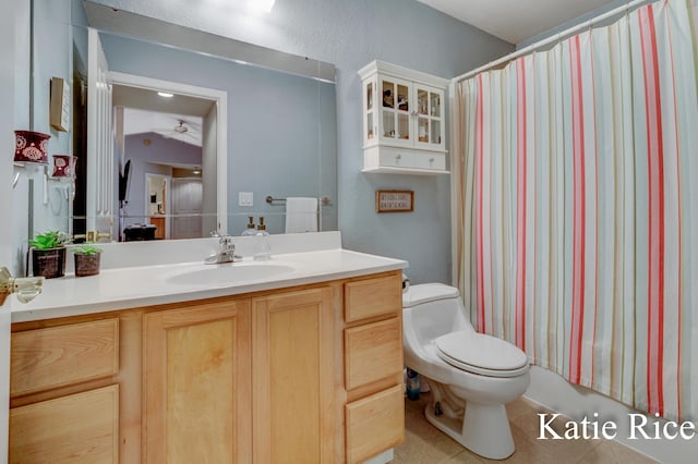full bath featuring ceiling fan, curtained shower, vanity, tile patterned floors, and toilet