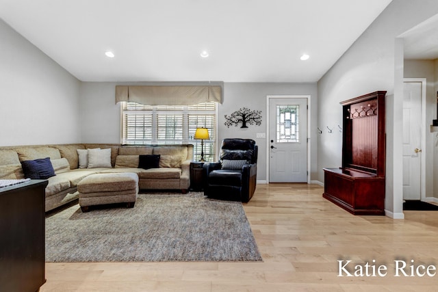 living room with recessed lighting, baseboards, and light wood finished floors