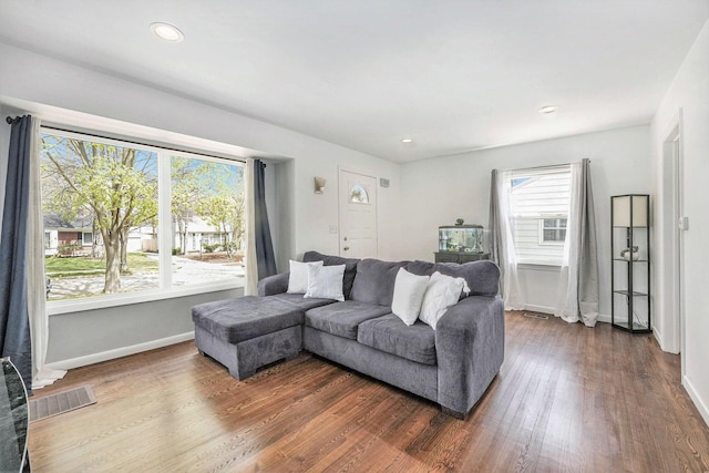 living room with recessed lighting, baseboards, dark wood finished floors, and visible vents