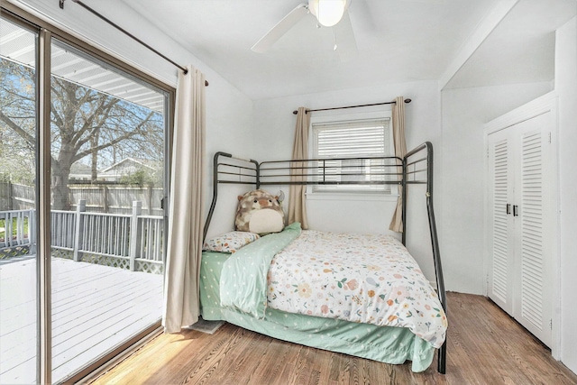 bedroom with access to outside, a ceiling fan, and wood finished floors