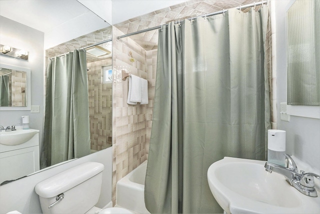 bathroom featuring toilet, a sink, and shower / tub combo