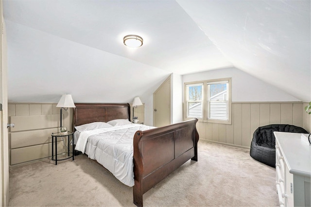 bedroom with vaulted ceiling and light colored carpet