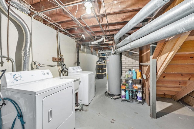 unfinished below grade area featuring washer and clothes dryer and water heater