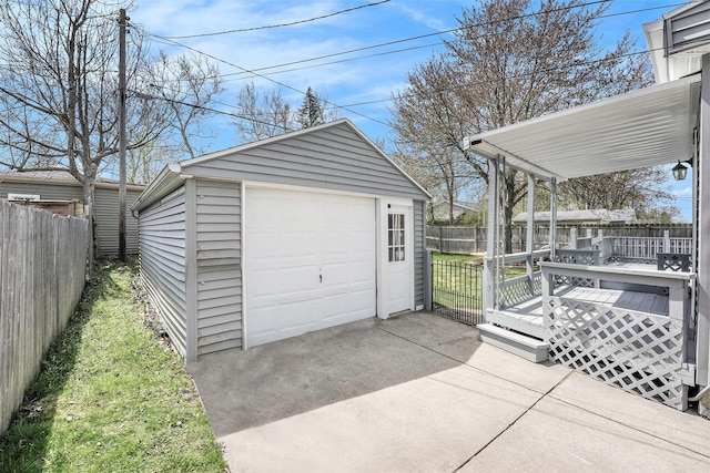 detached garage with fence and driveway
