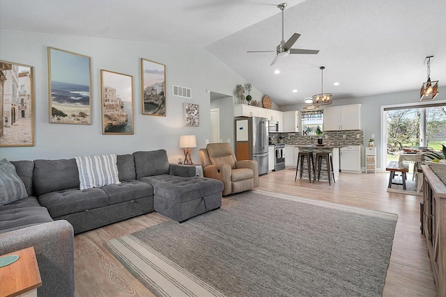 8308 E G Ave, Kalamazoo, MI 49048 - living room featuring visible vents, light wood finished floors, ceiling fan with notable chandelier, recessed lighting, and vaulted ceiling