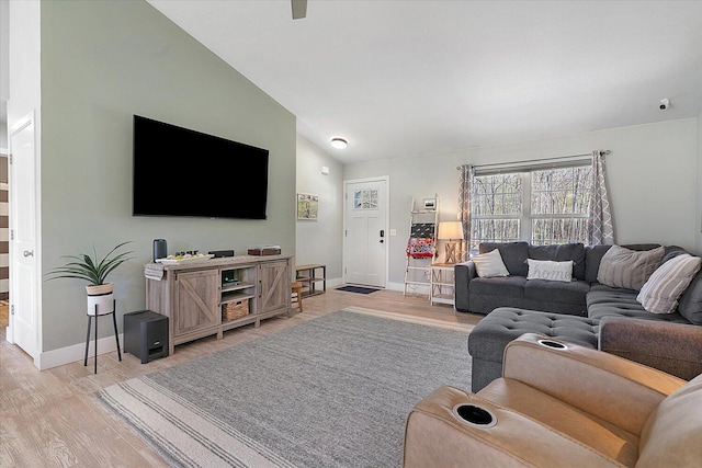 8308 E G Ave, Kalamazoo, MI 49048 - living room with light wood-style floors, baseboards, and lofted ceiling