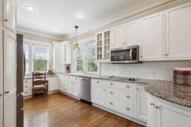602 N Kalamazoo Ave, Marshall, MI 49068 - kitchen with stainless steel appliances, white cabinets, healthy amount of natural light, crown molding, and recessed lighting