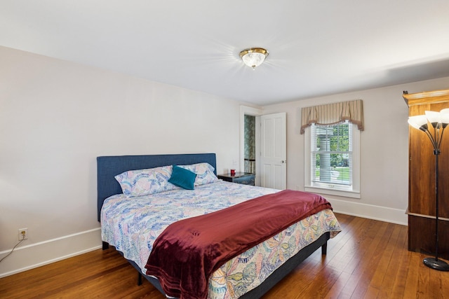 602 N Kalamazoo Ave, Marshall, MI 49068 - bedroom with baseboards and hardwood / wood-style floors
