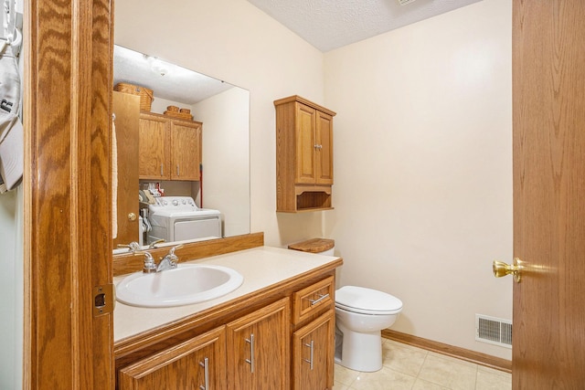 bathroom with toilet, a textured ceiling, tile patterned floors, washer / clothes dryer, and visible vents