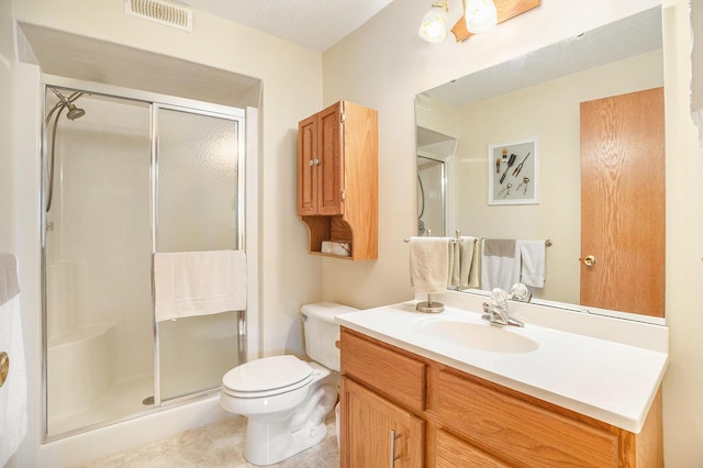 full bath featuring vanity, toilet, tile patterned floors, a shower stall, and visible vents