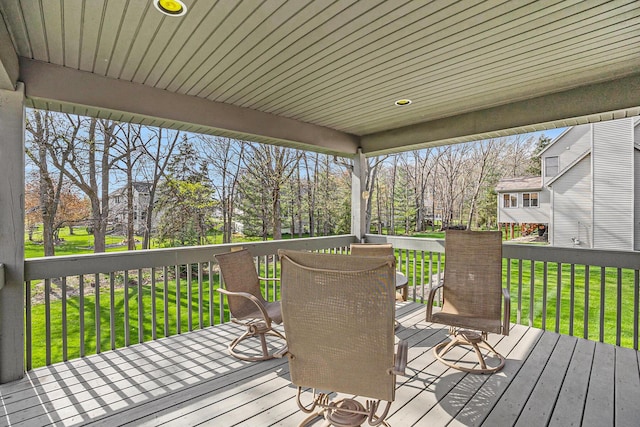 wooden terrace featuring a yard