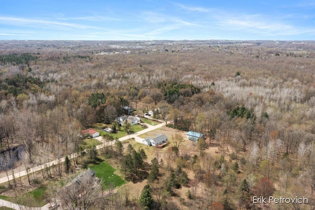 drone / aerial view featuring a forest view